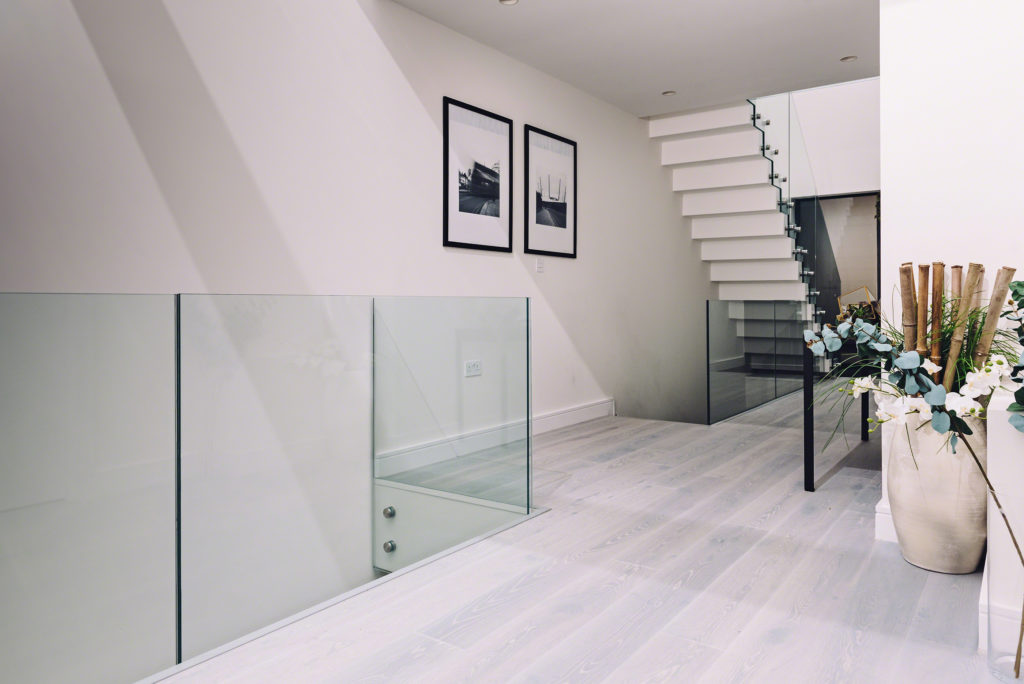 Glass Standoff Buttons on staircase in a modern home