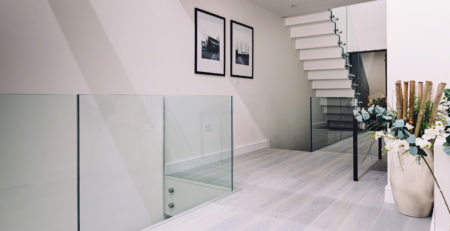 Glass Standoff Buttons on staircase in a modern home
