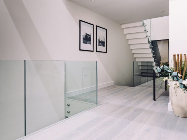 Glass Standoff Buttons on staircase in a modern home