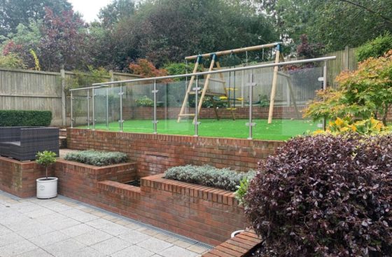 post & rail system protecting drop from garden to patio